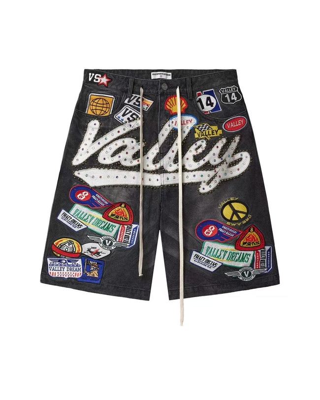 Valley Vintage Acid Washed Black Denim Jorts Multi Racing Patch Embellished Rhinestone Cursive Logo Baggy Wide Leg Unisex Y2K Hip Hop Streetwear Knee Length Denim Shorts Hover Image